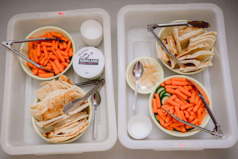 alt='humans fresh veggies and bread'